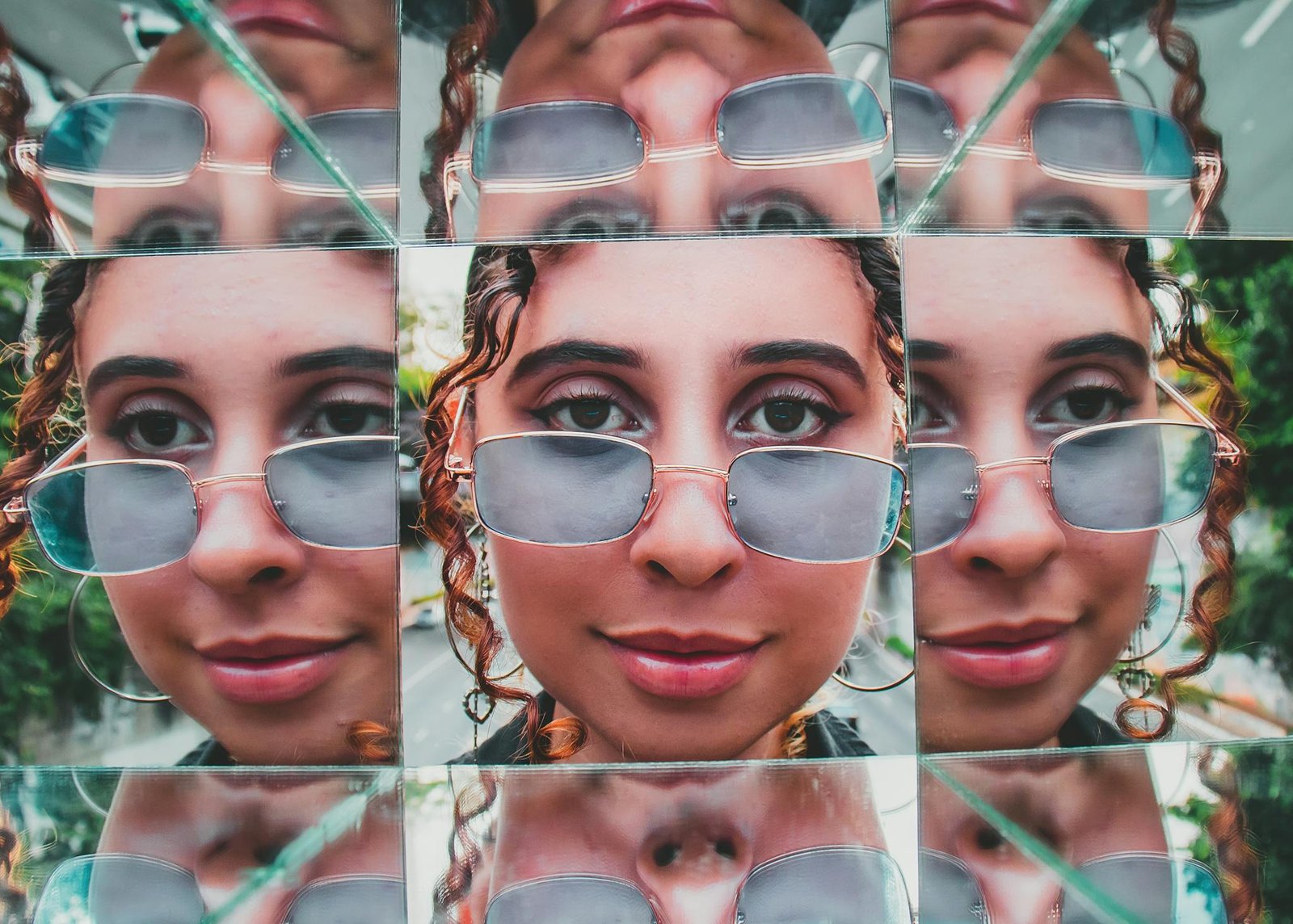 Creative portrait of a young woman with sunglasses reflecting multiple times in a vibrant artistic collage.