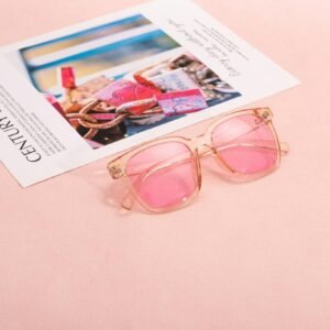 Pink sunglasses on a magazine page with a soft pastel background, capturing a chic and modern vibe.